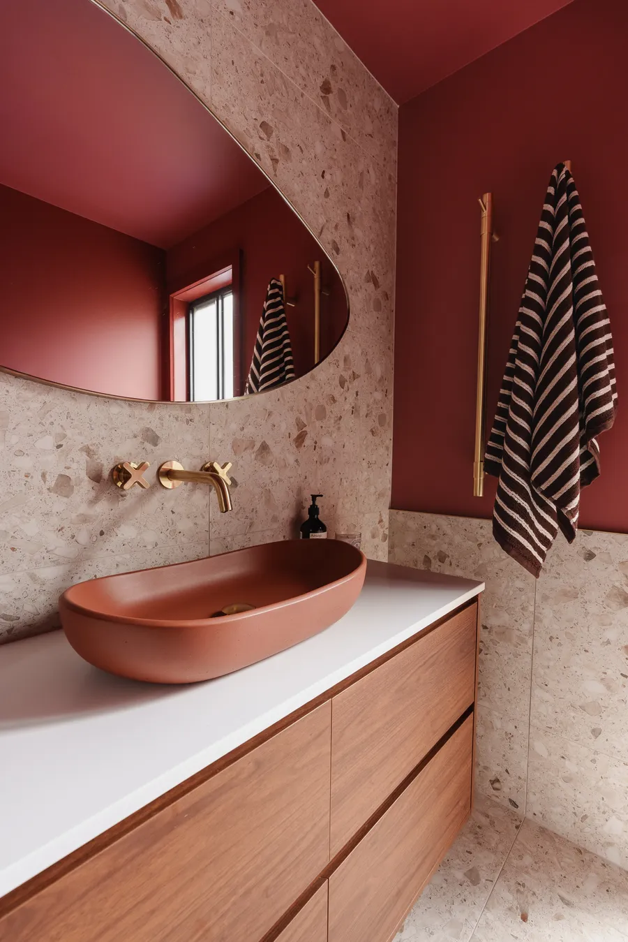 Terracotta basin with brass tapware and terrazzo wall, Grange Drive bathroom by MNA Builds