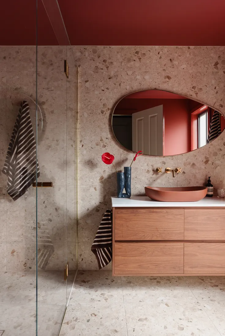 Terracotta basin with brass tapware and terrazzo wall, South Morang bathroom by MNA Builds
