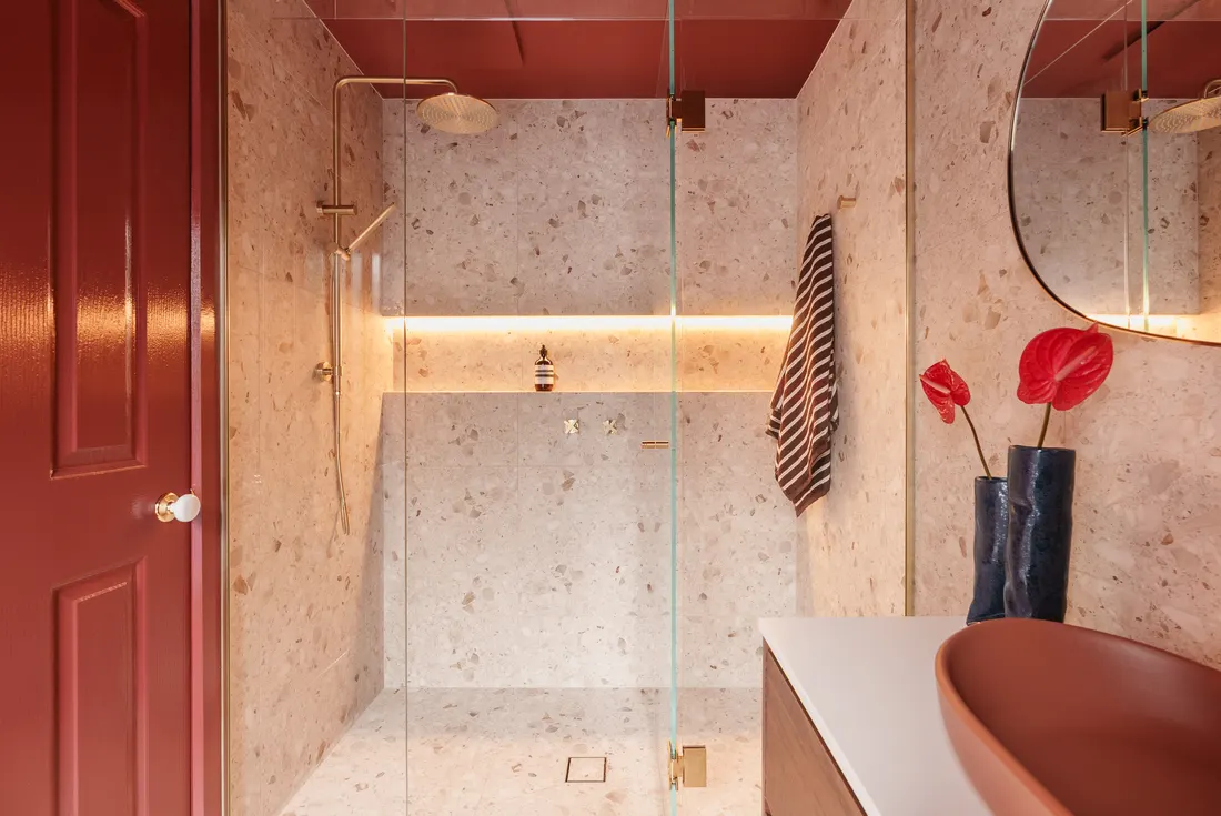 Recessed terrazzo shower with brass fittings by MNA Builds