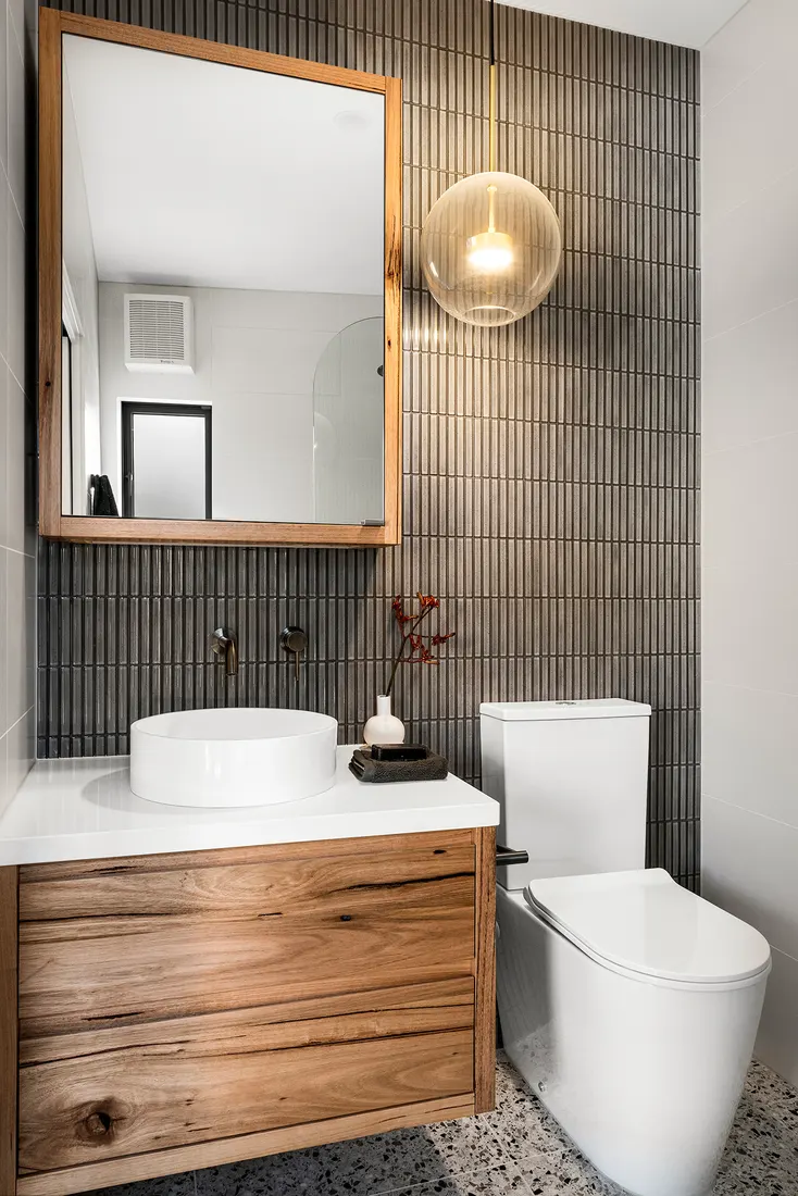Timber vanity with vessel basin and tiled feature wall by MNA Builds