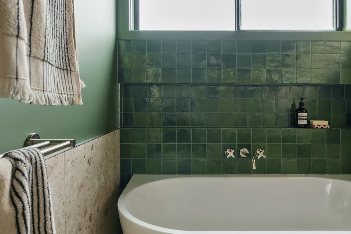 Green zellige tiled bathroom with freestanding bath by MNA Builds